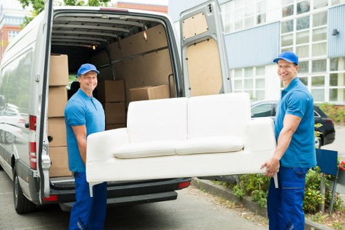 Crew members lifting and loading household waste into a van